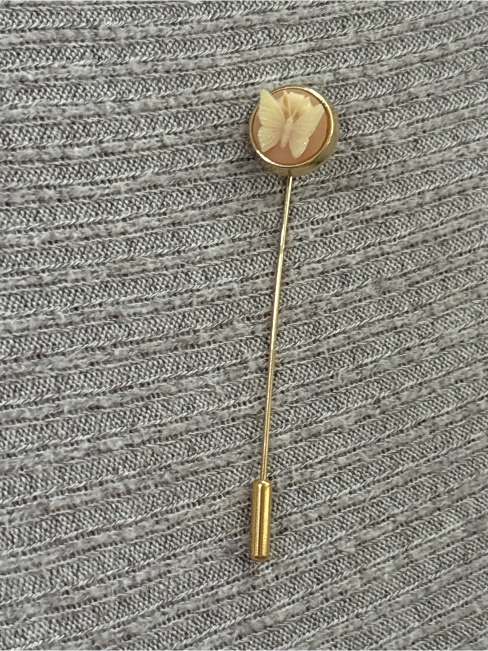 Vintage Trifari signed gold tone round white butterfly on peach background pin